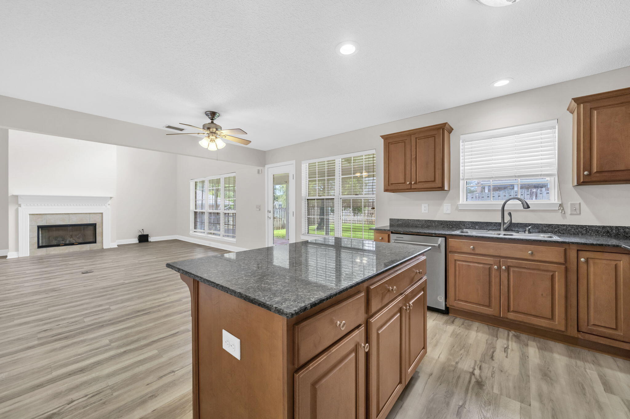 202 Gracie Lane Niceville, FL 32578 - Photo 23 of 47 a kitchen with granite countertop a sink stove and cabinets
