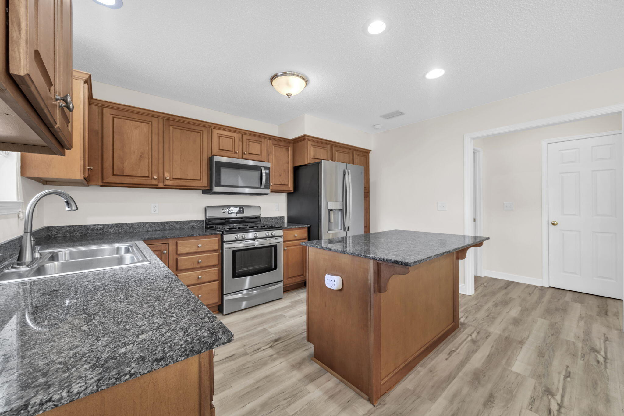202 Gracie Lane Niceville, FL 32578 - Photo 24 of 47 a kitchen with stainless steel appliances granite countertop a stove a sink and a refrigerator