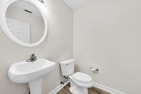 a bathroom with a sink a mirror and toilet