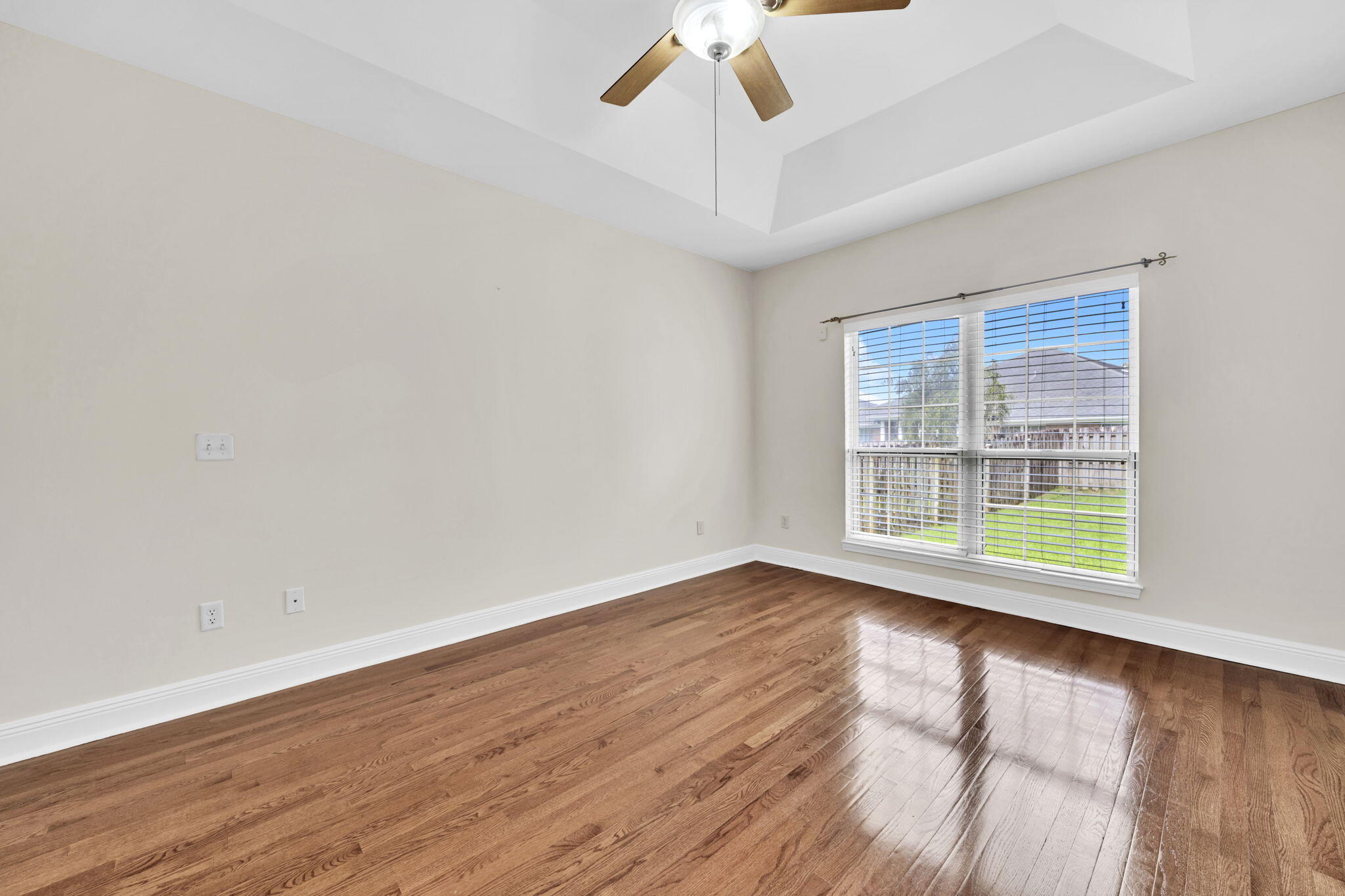 202 Gracie Lane Niceville, FL 32578 - Photo 26 of 47 a view of an empty room with wooden floor and a window