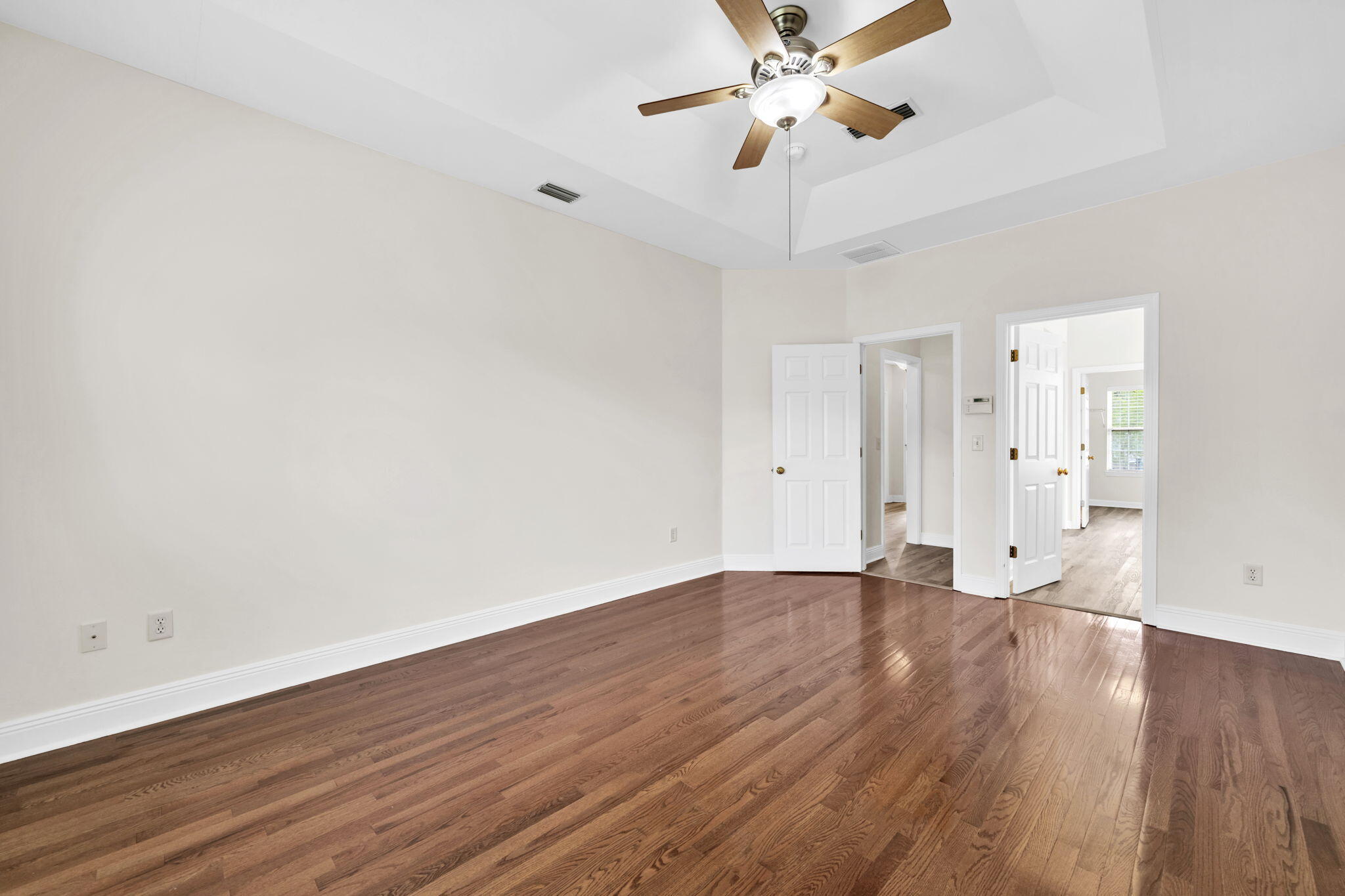 202 Gracie Lane Niceville, FL 32578 - Photo 27 of 47 a view of an empty room with wooden floor