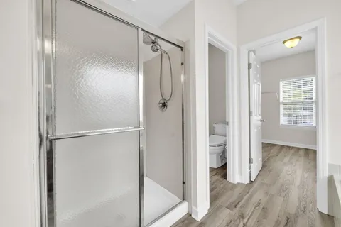 a bathroom with a glass shower door
