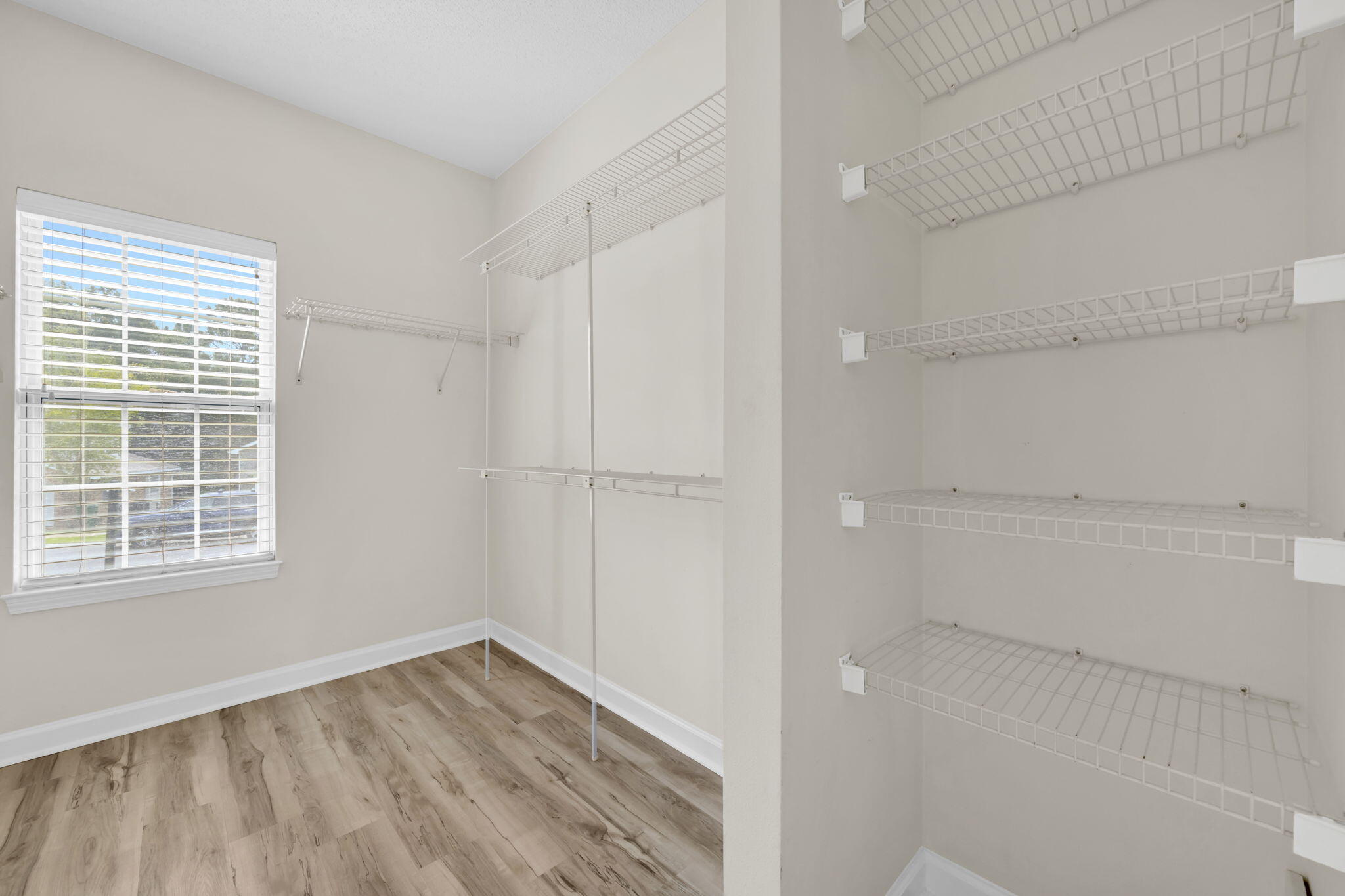202 Gracie Lane Niceville, FL 32578 - Photo 31 of 47 a view of an empty room with wooden floor and a window