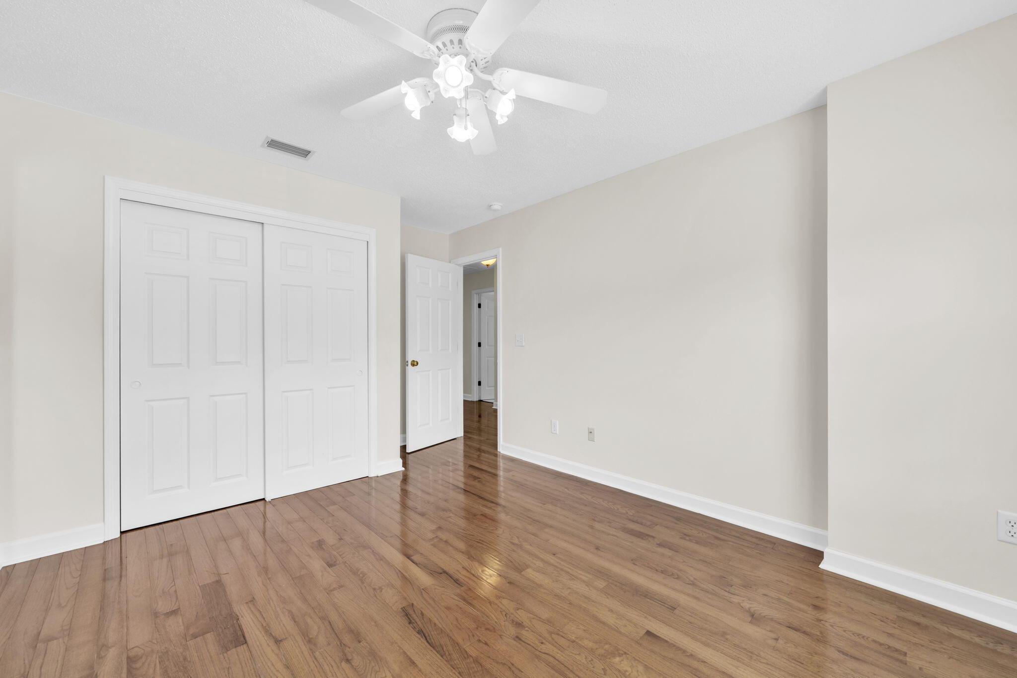 202 Gracie Lane Niceville, FL 32578 - Photo 34 of 47 a view of an empty room with wooden floor