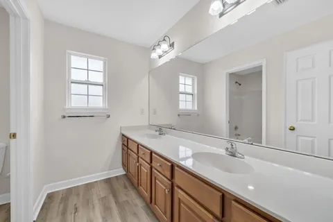 a bathroom with a double vanity sink and a mirror