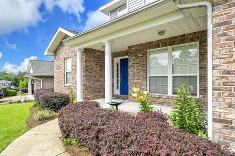 a front view of a house with garden