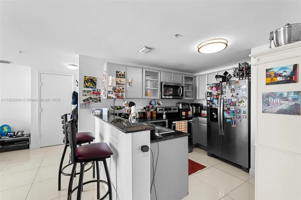 a view of a kitchen with refrigerator and dining table