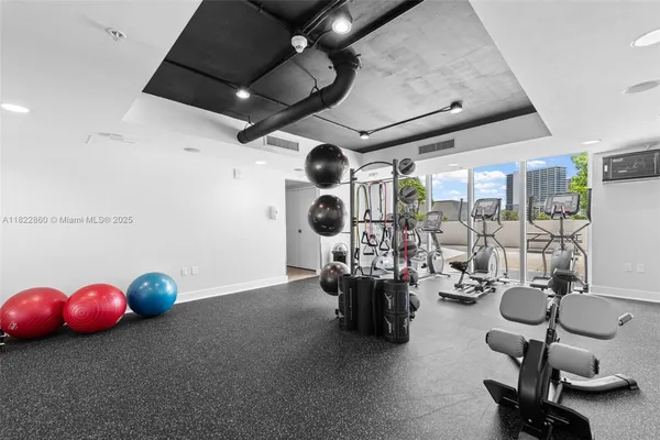a room with gym equipment and large mirror