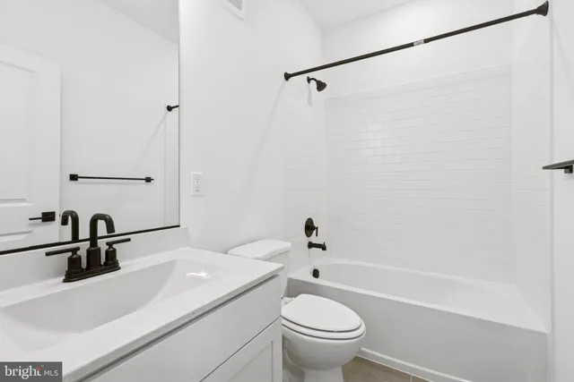 a large kitchen with kitchen island a stove a sink dishwasher a dining table and chairs with wooden floor