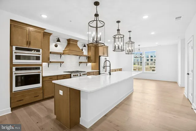 a kitchen with stainless steel appliances a stove and more cabinets