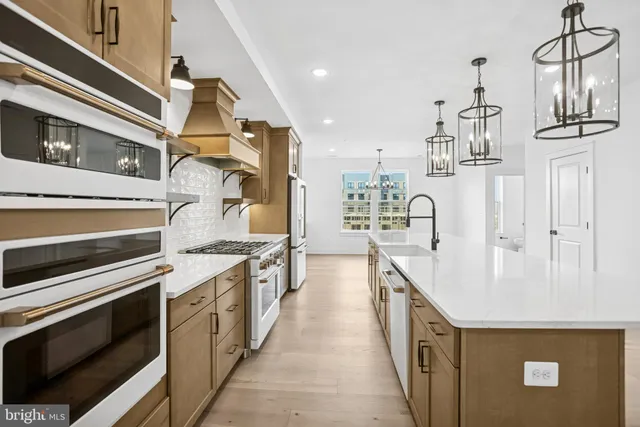 a view of a kitchen with cabinets and wooden floor