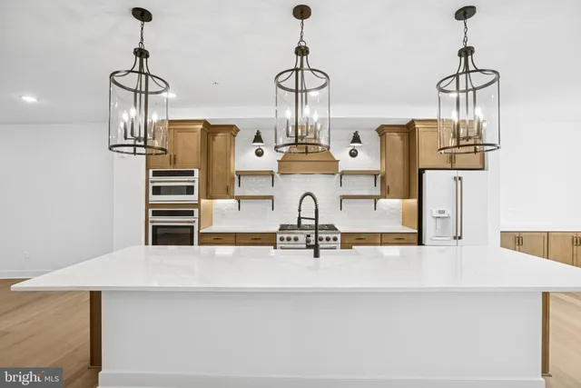a bathroom with a sink mirror and a shower