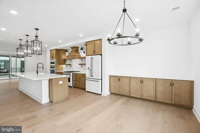 a kitchen with cabinets a sink and appliances