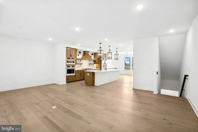 a view of a kitchen with wooden floor