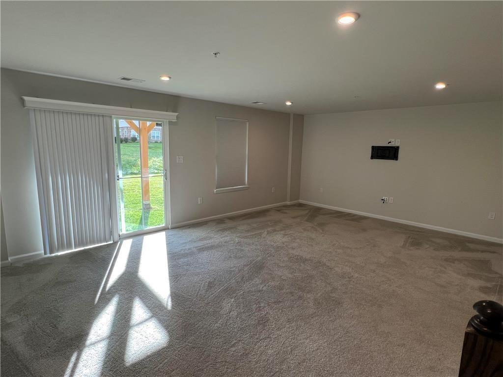 2356 Raya Way Easton, PA 18045 - Photo 22 of 28 Sliding glass doors open to the yard from this carpeted living area with recessed lighting.
