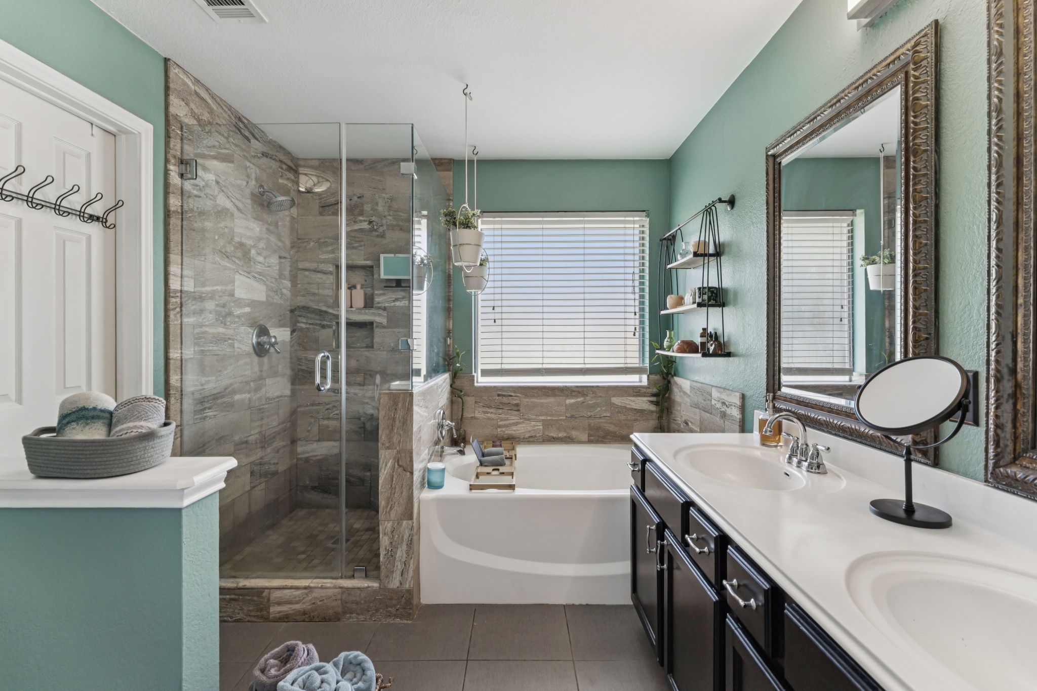 2412 Chestnut Path Round Rock, TX 78664 - Photo 12 of 26 Relaxation awaits in a primary bathroom featuring a soaking tub, glass-enclosed shower, and dual vanities.