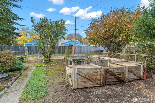 a view of a house with backyard stove and sitting area