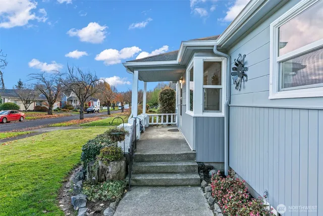 a view of a pathway of a house with a yard