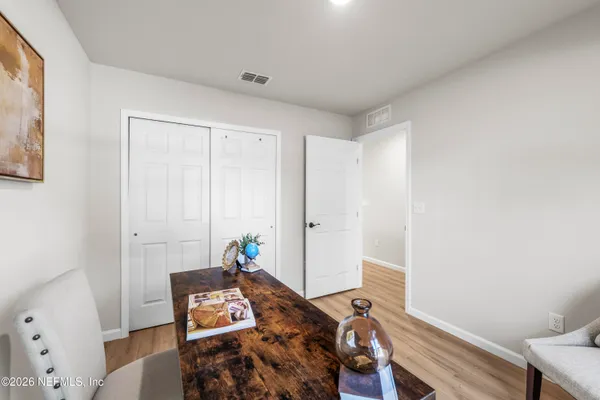 a view of a workspace with furniture and wooden floor
