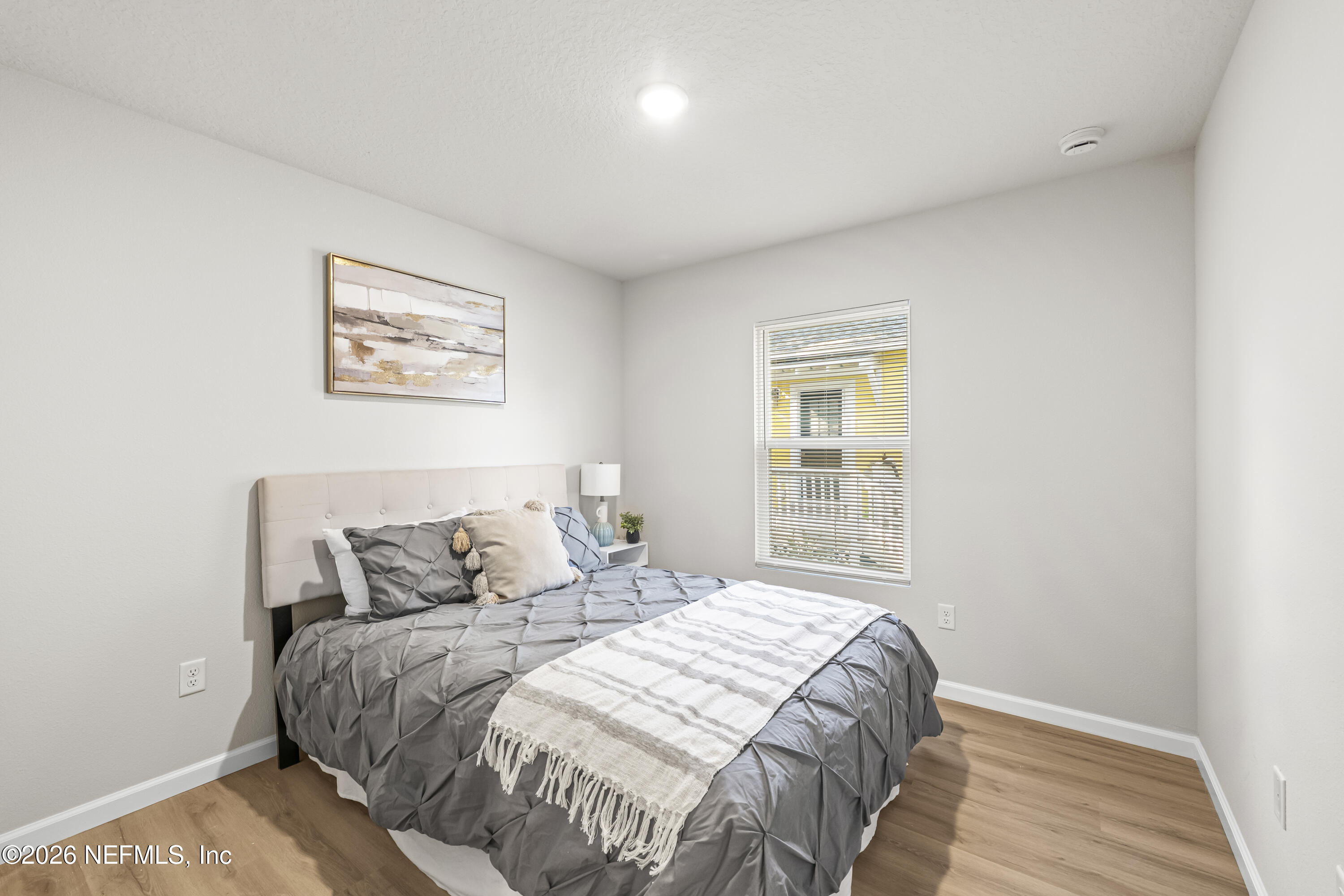 4355 Longmire Road Middleburg, FL 32068 - Photo 16 of 19 a bedroom with a bed and a window