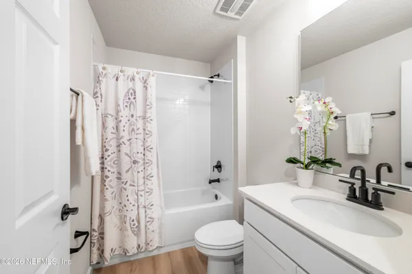 a bathroom with a sink toilet tub and shower