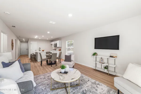 a living room with furniture and a flat screen tv