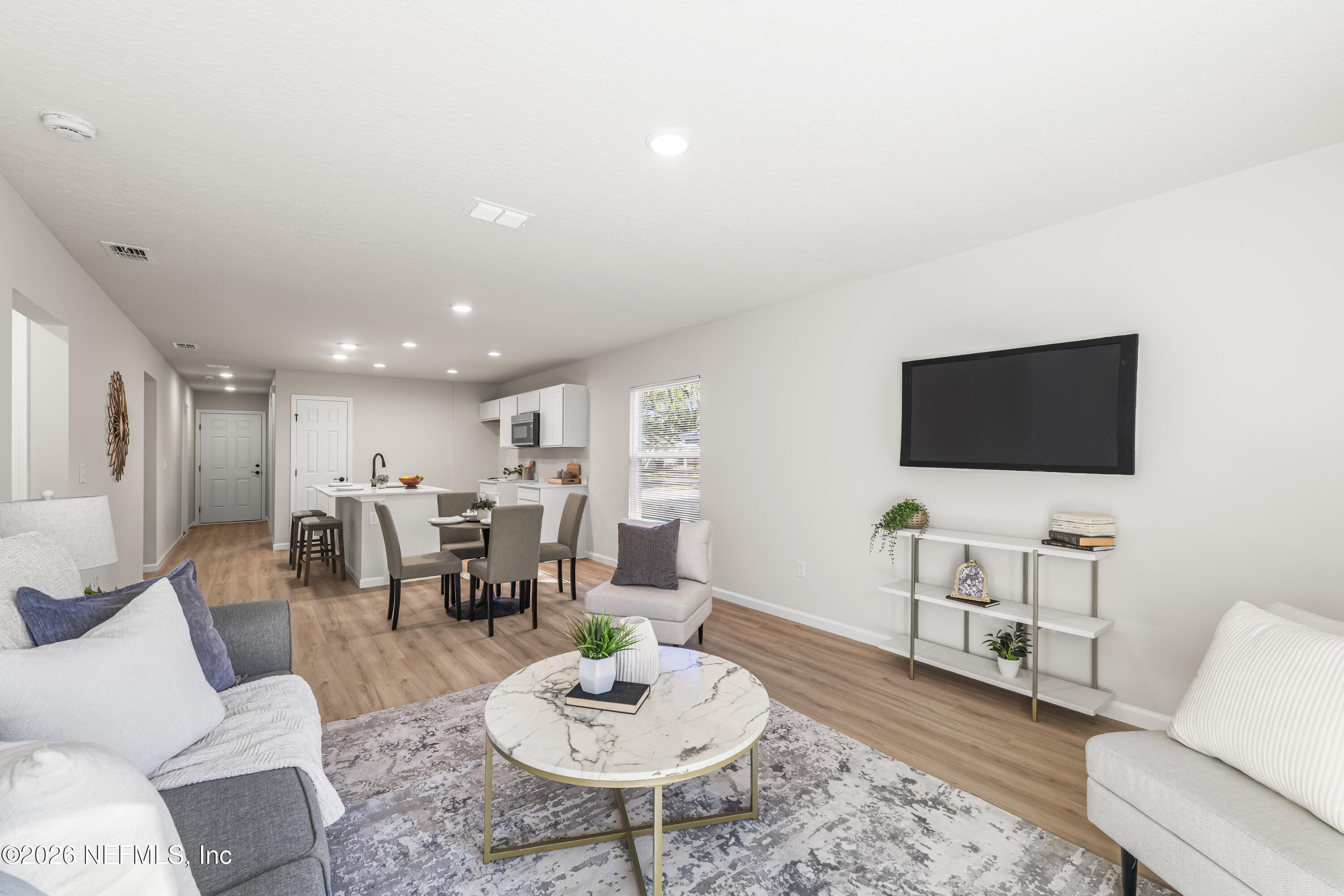 4355 Longmire Road Middleburg, FL 32068 - Photo 2 of 19 a living room with furniture and a flat screen tv