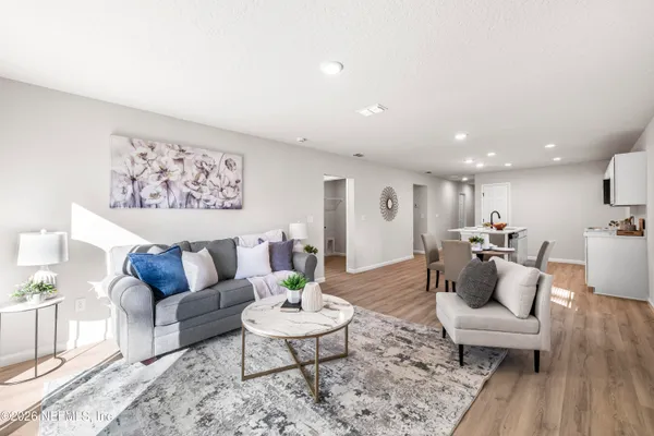 a living room with furniture and wooden floor
