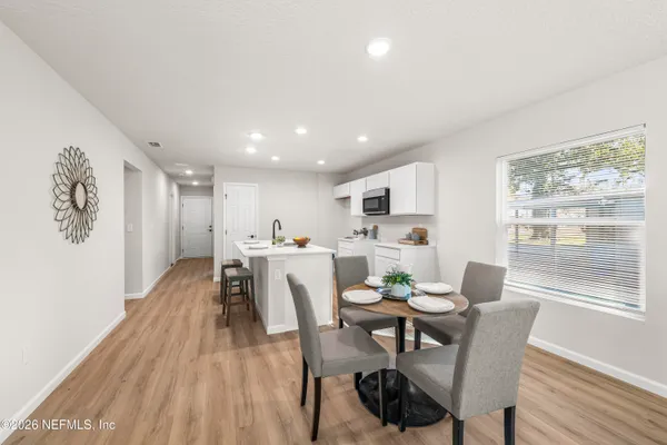 a dining room with furniture and wooden floor