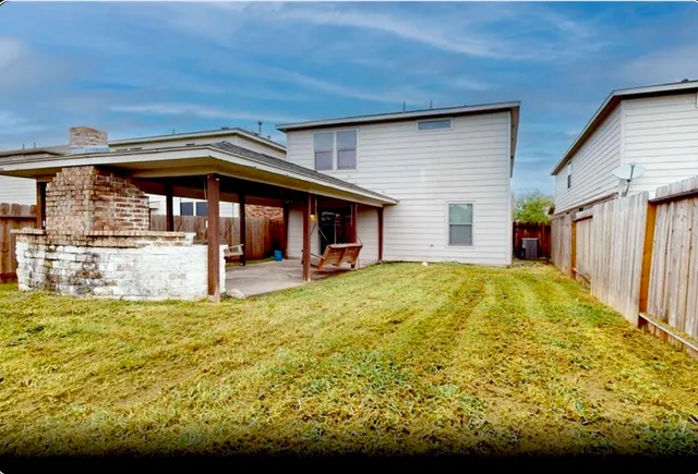 a view of house that has a small yard