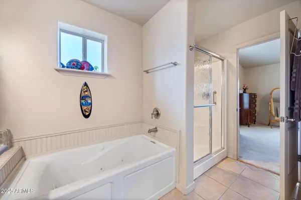 a bathroom with a granite countertop double vanity sink and a mirror