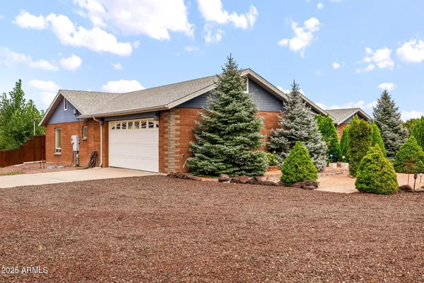 a front view of a house with a yard and a garage