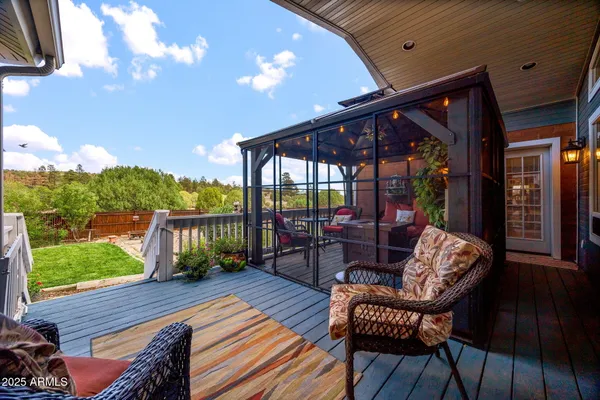 a view of a patio with chairs and a grill