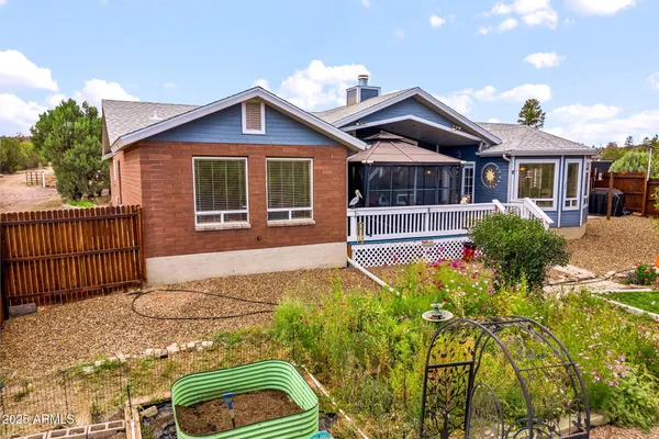 a view of a house with a patio and a yard