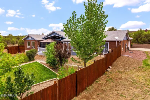 a front view of a house with a yard and potted plants