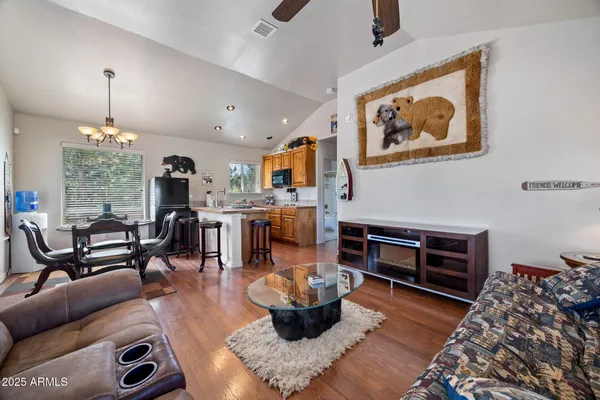 a kitchen with a sink and living room view
