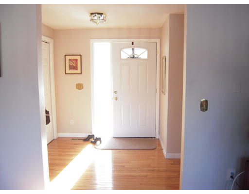 53 Stagecoach Road Amherst, MA 01002 - Photo 3 of 18 a view of a hallway with wooden floor and a livingroom