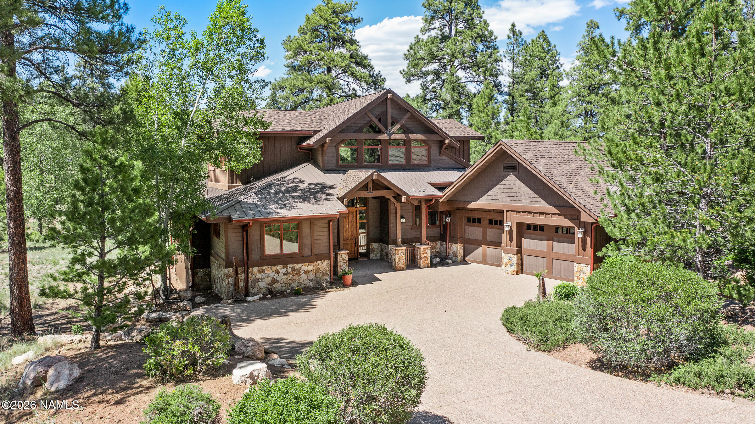 2214 East Del Rae Drive Flagstaff, AZ 86005 - Photo 2 of 45 a front view of a house with yard and green space