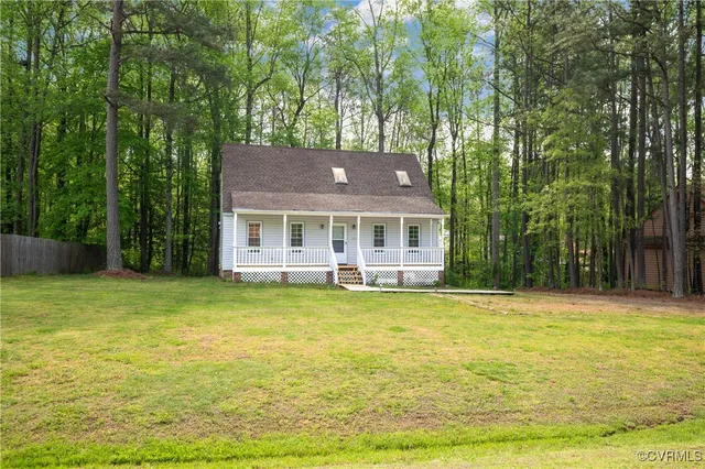 a front view of a house with swimming pool having outdoor seating
