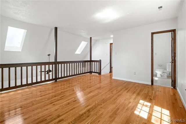 a view of a room with wooden floor