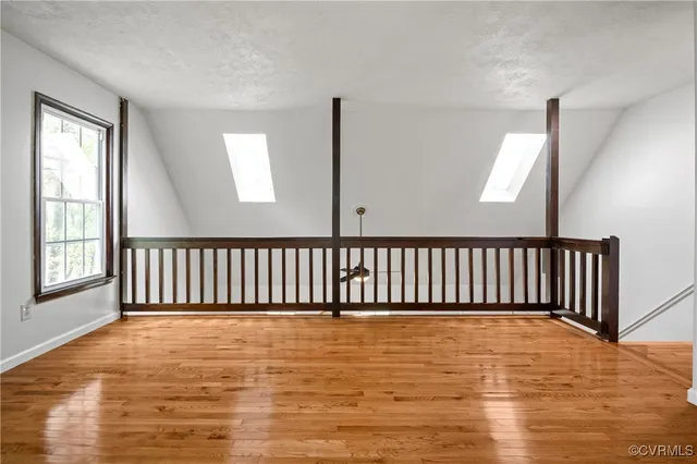 a view of staircase with window and wooden floor