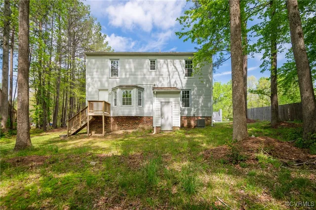 a view of a house with backyard porch and sitting area