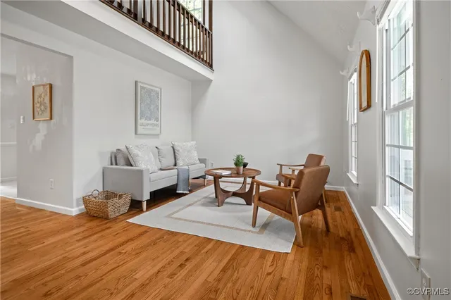 a living room with furniture and a wooden floor