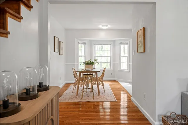 a dining room with furniture and wooden floor