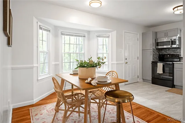 a dining room with furniture and window