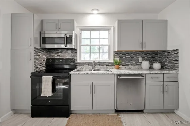 a kitchen with a sink stove and microwave