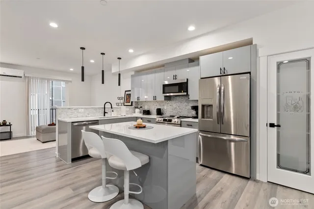 a kitchen with stainless steel appliances a sink a stove and a microwave