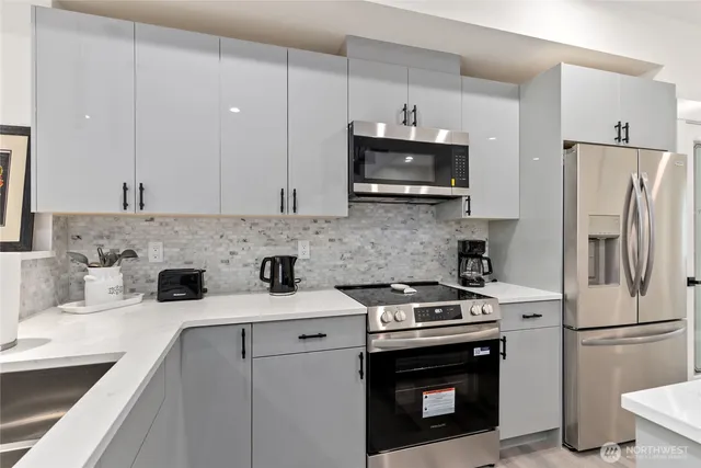 a kitchen with counter top space and appliances