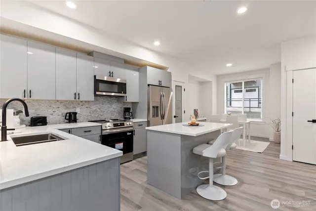 a kitchen with a sink cabinets and wooden floor