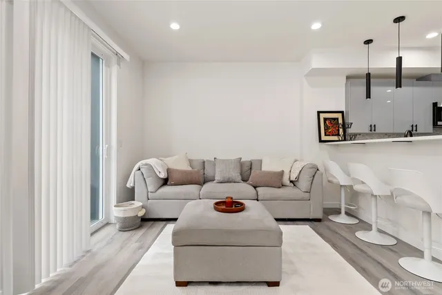 a living room with furniture and kitchen view